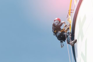 Male  worker rope access  inspection of thickness storage tank